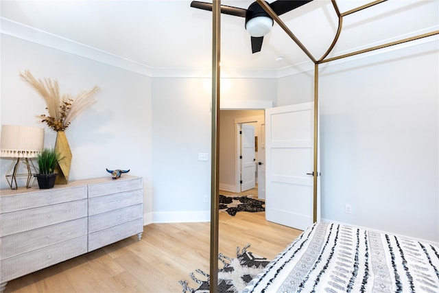 bedroom with a closet, light hardwood / wood-style flooring, ceiling fan, and ornamental molding