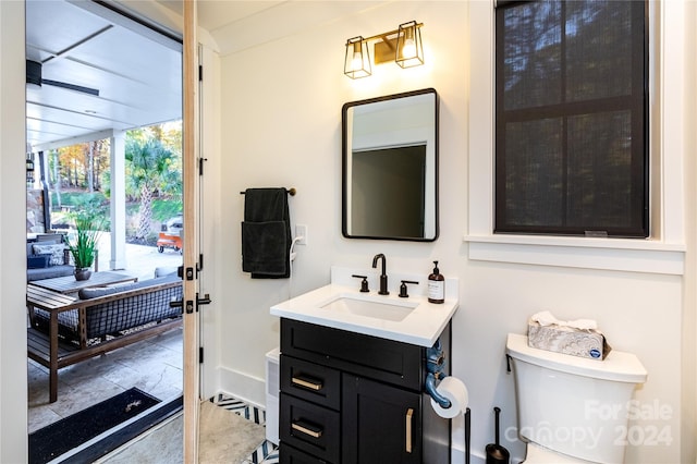 bathroom featuring vanity and toilet