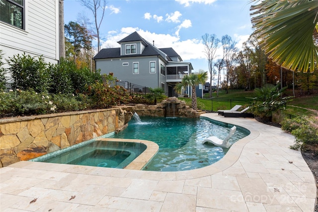 view of swimming pool featuring an in ground hot tub and pool water feature