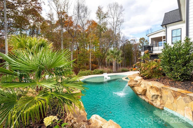 view of swimming pool with pool water feature