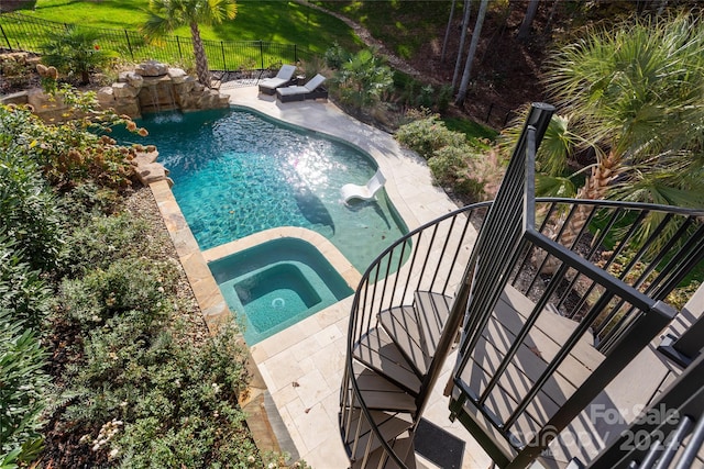 view of pool with an in ground hot tub and a patio