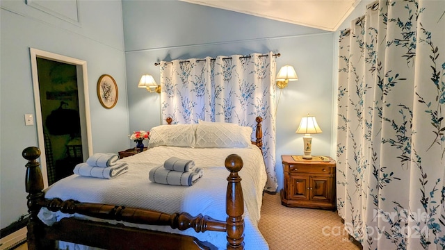 carpeted bedroom featuring ornamental molding and vaulted ceiling