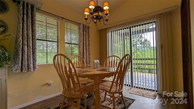 dining area with hardwood / wood-style flooring and an inviting chandelier