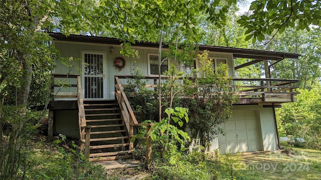 view of front of property with a deck and a garage