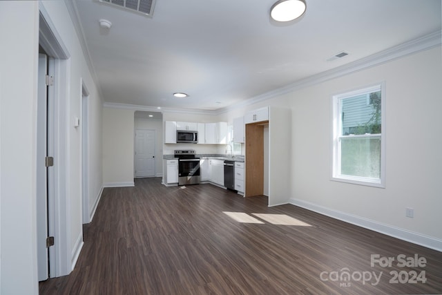 kitchen with appliances with stainless steel finishes, dark hardwood / wood-style flooring, ornamental molding, sink, and white cabinetry