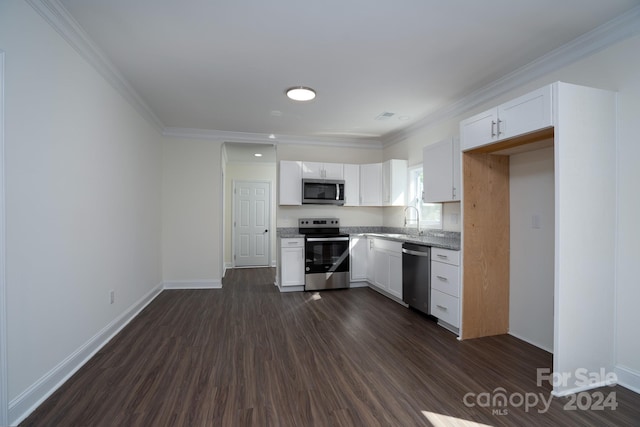 kitchen featuring white cabinets, stainless steel appliances, dark hardwood / wood-style floors, and crown molding