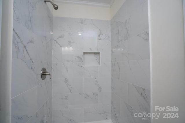 bathroom with a tile shower