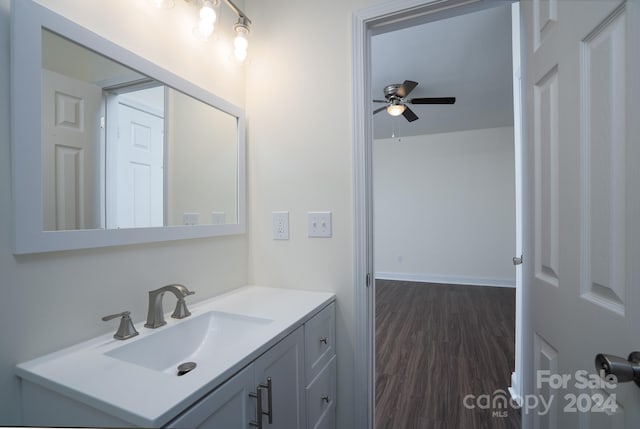 bathroom with vanity, hardwood / wood-style flooring, and ceiling fan