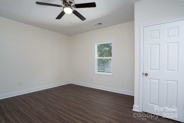 unfurnished room with ceiling fan and dark hardwood / wood-style flooring