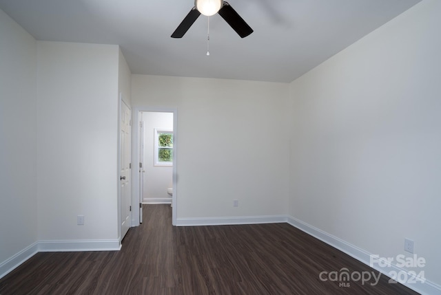 empty room featuring ceiling fan and dark hardwood / wood-style flooring