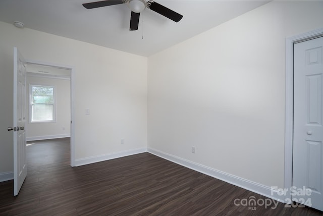 spare room with ceiling fan and dark wood-type flooring