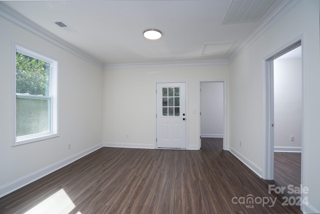 spare room featuring crown molding and dark hardwood / wood-style floors