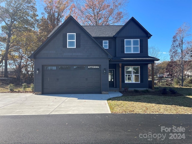 view of front of home featuring a front yard and a garage