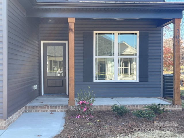 doorway to property featuring covered porch