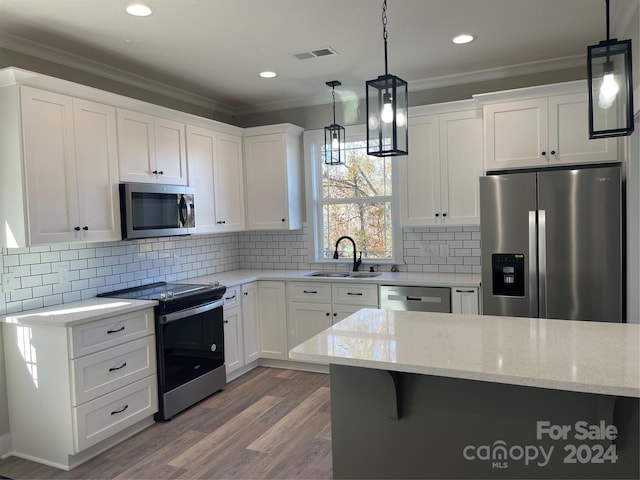 kitchen featuring stainless steel appliances, white cabinetry, ornamental molding, and sink