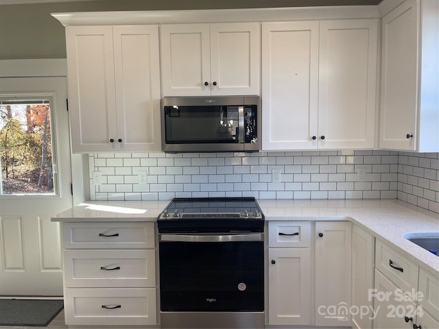 kitchen featuring white cabinets, light stone countertops, and appliances with stainless steel finishes