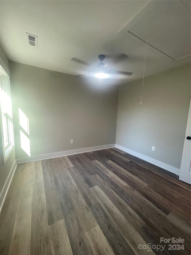 unfurnished room featuring dark hardwood / wood-style flooring