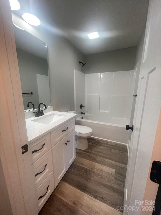 full bathroom with shower / bath combination, vanity, toilet, and wood-type flooring