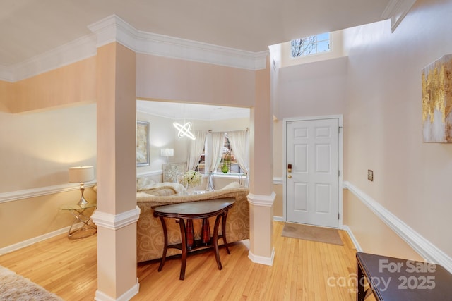 entryway with wood finished floors, decorative columns, and a healthy amount of sunlight