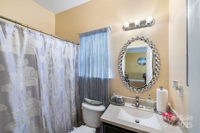 bathroom with toilet and vanity