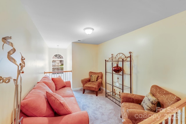 living area featuring baseboards and light colored carpet