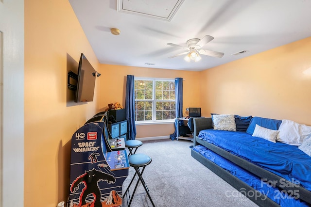 carpeted bedroom featuring baseboards, visible vents, and a ceiling fan