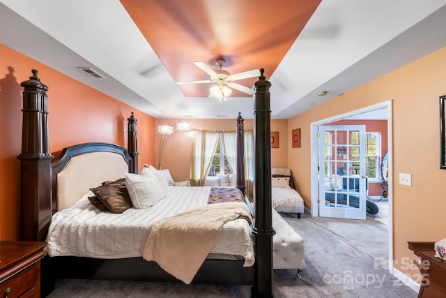 bedroom featuring carpet, visible vents, baseboards, and multiple windows