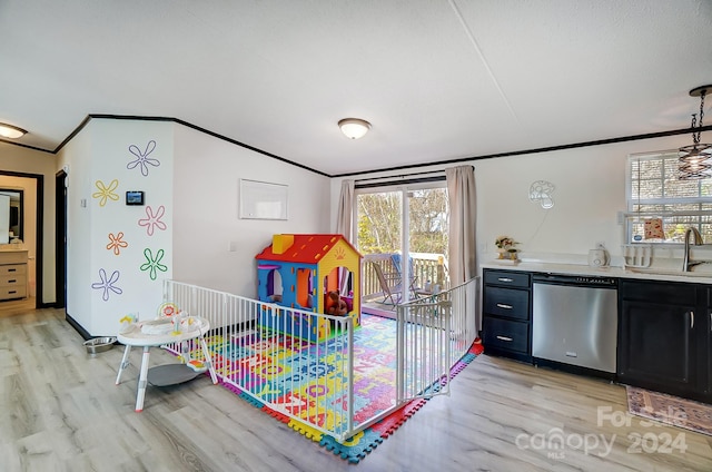 playroom featuring light wood-type flooring, ornamental molding, and sink