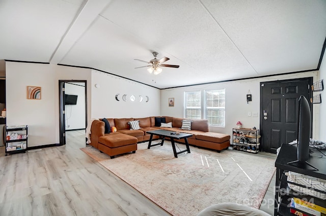 living room featuring ceiling fan, light wood-type flooring, and a textured ceiling