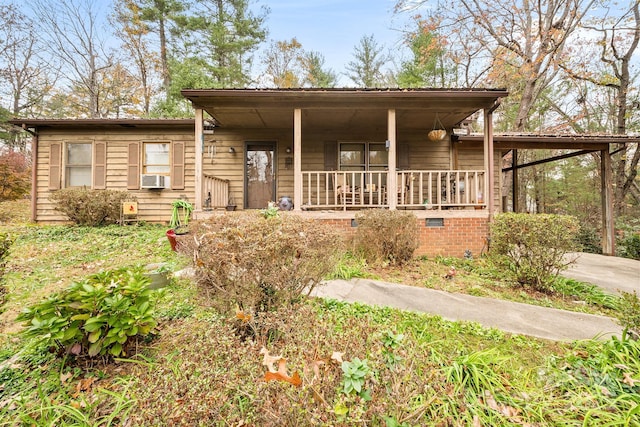 view of front of home featuring a porch and cooling unit