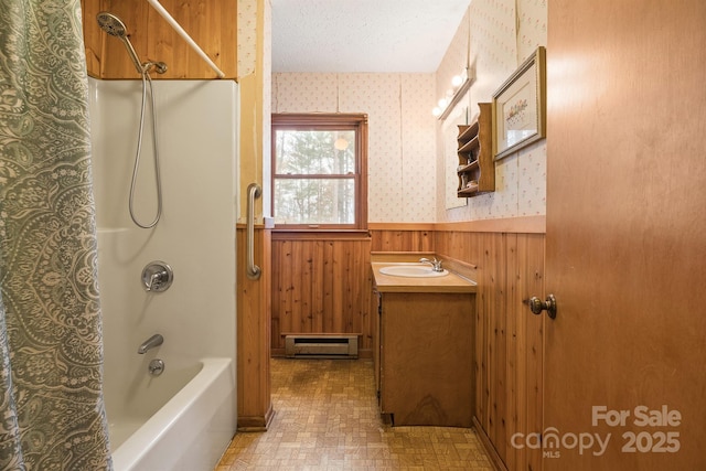 bathroom featuring bathtub / shower combination, a textured ceiling, vanity, wooden walls, and a baseboard radiator