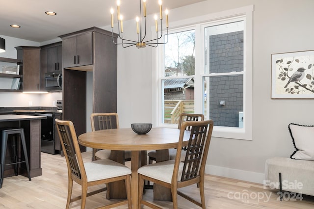 dining area with a chandelier and light wood-type flooring