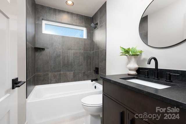 full bathroom with toilet, vanity, and tiled shower / bath