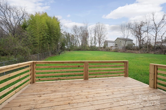 wooden terrace featuring a lawn