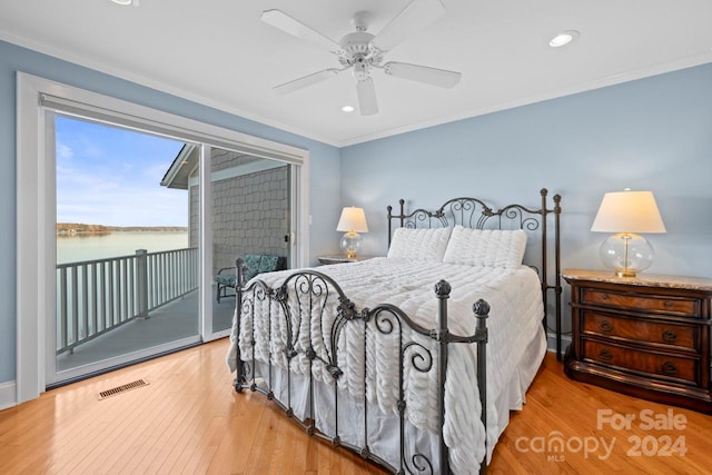 bedroom featuring ornamental molding, access to outside, ceiling fan, a water view, and light hardwood / wood-style floors