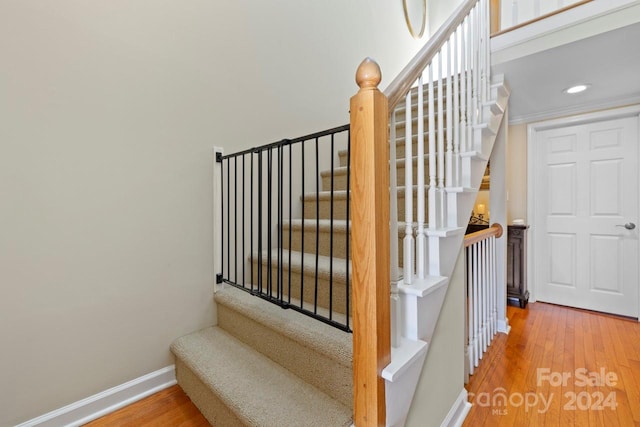 stairs with hardwood / wood-style flooring