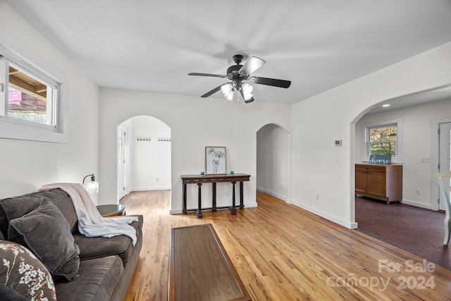 living room with hardwood / wood-style floors and ceiling fan