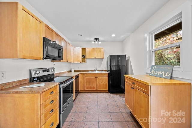 kitchen featuring sink, black appliances, and light brown cabinets