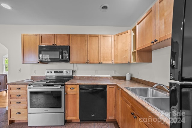 kitchen with sink, dark hardwood / wood-style floors, and black appliances