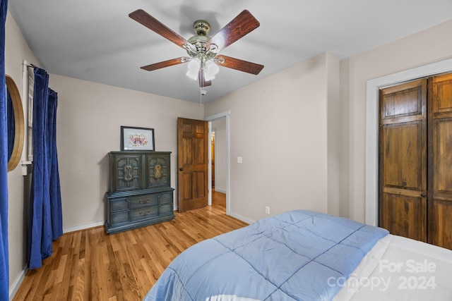 bedroom with ceiling fan, light wood-type flooring, and a closet