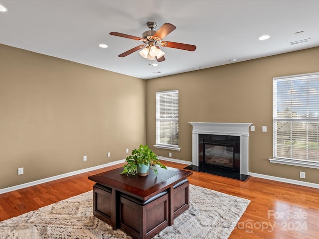 living room with ceiling fan and light wood-type flooring