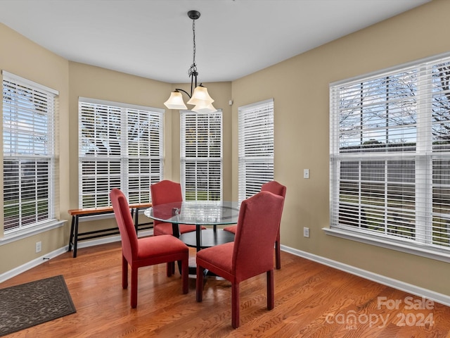 dining room with hardwood / wood-style flooring and a notable chandelier