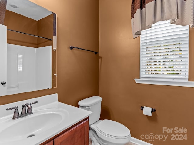 bathroom featuring vanity and toilet