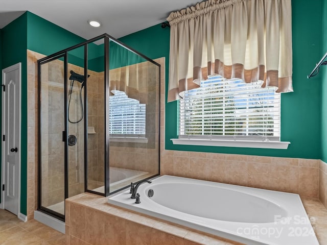 bathroom with tile patterned floors and separate shower and tub