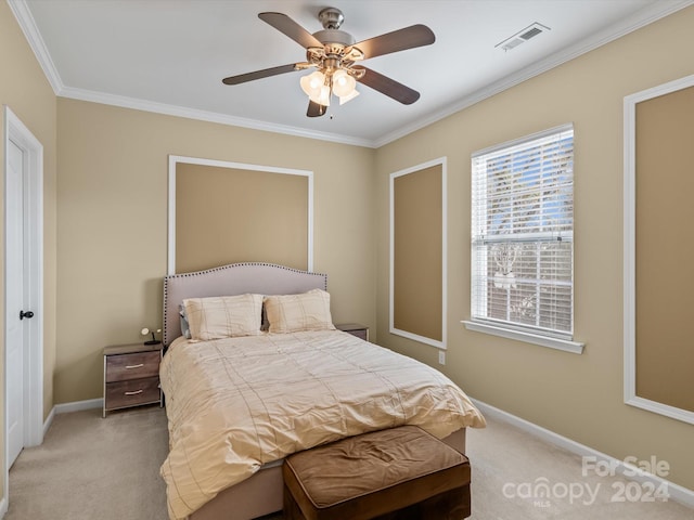 carpeted bedroom with ceiling fan and ornamental molding