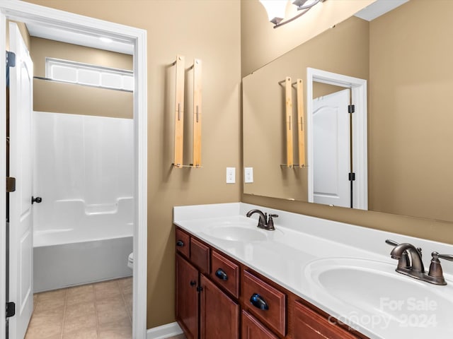 bathroom featuring tile patterned floors, vanity, and toilet