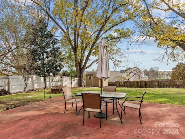 view of patio featuring a storage unit