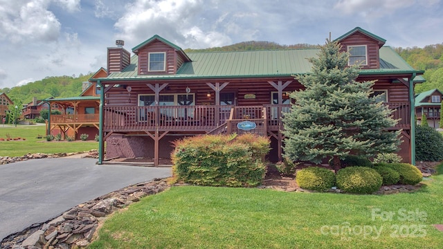 cabin with a front yard and covered porch