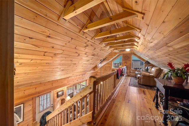 interior space featuring wood ceiling, lofted ceiling with beams, hardwood / wood-style flooring, and wood walls