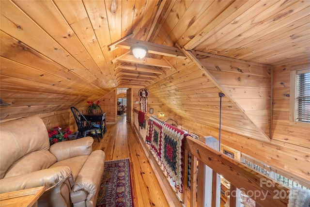 sitting room with vaulted ceiling, wooden walls, hardwood / wood-style floors, and wooden ceiling